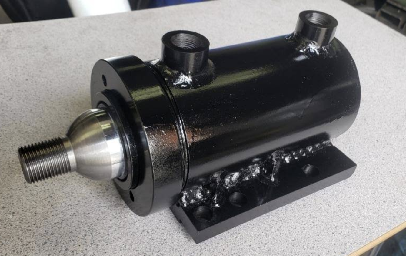 Black fabricated hydraulic assembly with polished metal shaft
